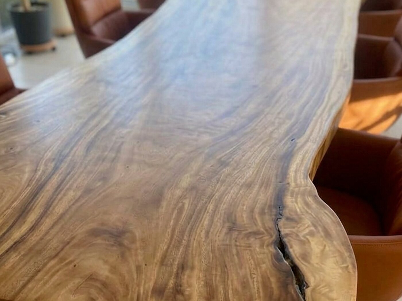 The open seam along the live edge, seen close against the rippled grain