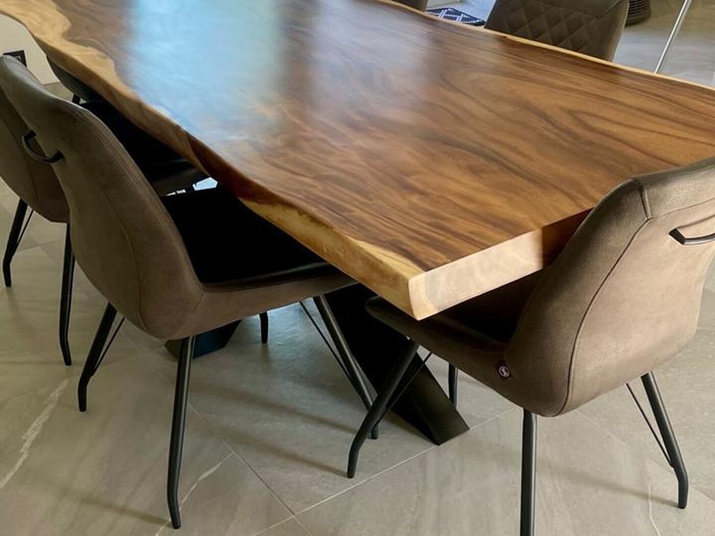 The table from a corner, the splayed frame and chair legs beneath it